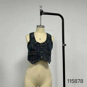 Detailed close-up of dark blue washed denim vest featuring V-neck and flap pockets