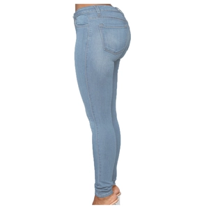 Detail view of light blue skinny jeans showing slim fit and back pocket design