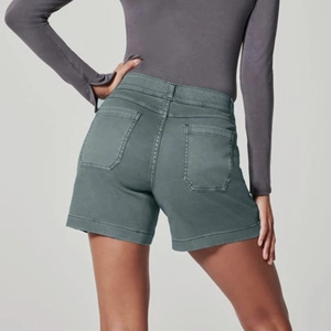 Close-up back view of high-waist sage green denim shorts with large functional pockets