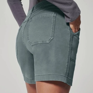 Macro detail of slim-fit stretchy high-waisted denim shorts showing back pockets and stitching