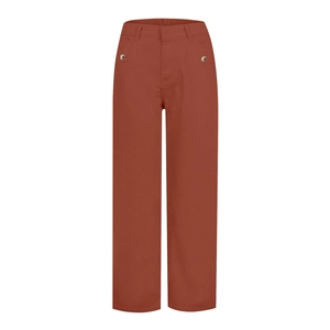 Close-up of rust red high-waisted trousers with double silver metal buttons on waist