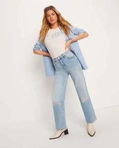 Close-up detail of light blue high-waist straight jeans with stylish distressed ripped knees