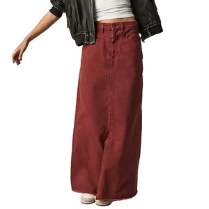 Detail of high-waisted burgundy denim maxi skirt featuring frayed hem and vertical stitching