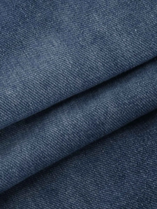 Gros plan de la texture du tissu denim bleu vintage de haute qualité avec sergé