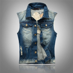 Detail of distressed denim vest featuring metal buttons and chest pocket embroidery
