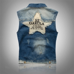 Detail of blue denim vest back featuring a large white star patch with frayed edges