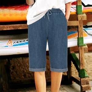 Detail of deep blue denim shorts featuring an elastic drawstring waist and cuffed hems