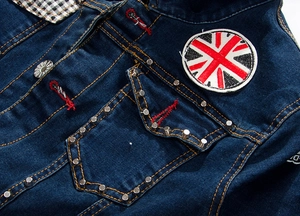Detail of dark blue denim jacket with silver studs and Union Jack embroidery patch