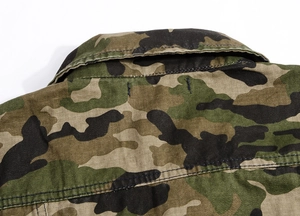 Detailed stitching and collar craftsmanship on a classic woodland camouflage denim vest