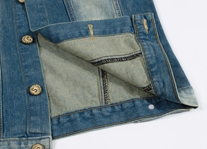 Detailed close-up of blue denim vest showing metal buttons and washed fabric texture