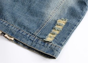 Detailed close-up showing the distressed denim hem and texture of a hooded blue vest