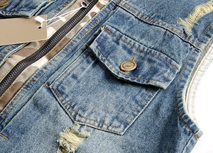 Slim fit denim vest for men featuring camouflage lining and distressed rip details