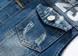 Detail of dark blue denim vest with eagle button and white towel embroidery 23