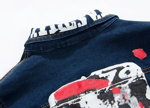 Detail of slim fit denim jacket featuring street style graffiti print and collar lettering