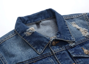 Detail of washed blue denim jacket featuring vintage bronze anchor-engraved buttons