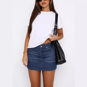 Slim fit dark blue denim mini skirt with washed texture paired with a white T-shirt