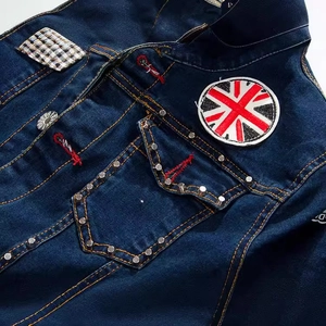 Slim fit denim jacket in dark blue with British flag patches and silver metal studs