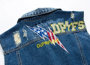 Detailed view of the blue denim vest featuring vintage embroidery and star lightning patterns