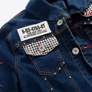 Men's slim fit dark blue denim jacket with rivet accents and plaid pocket detail