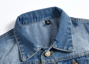 Close-up of denim vest collar featuring brass buttons and size label on blue fabric