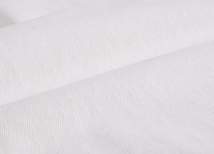 Macro close-up showing the fine texture and weave of the white denim cotton fabric