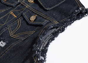 Close-up of dark blue denim vest featuring orange contrast stitching and frayed edges