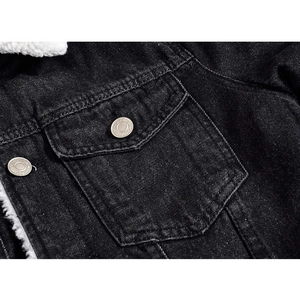 Close-up of denim jacket chest pocket with silver button and white sherpa lining