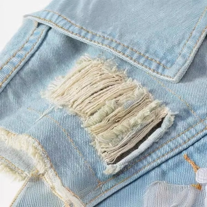 Slim fit light blue denim vest for men featuring heavy distressed frayed edges and micro details