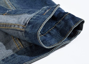 Close-up detail of blue denim vest cuff with sturdy yellow contrast double stitching