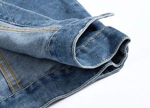 Detail of high-density denim fabric with durable yellow contrast stitching on the hem