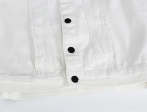 Detail of white denim vest with premium black buttons and vertical stitching