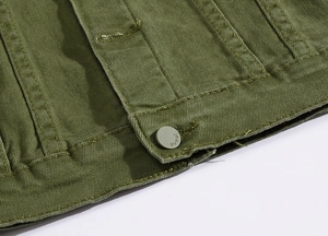 Detail of army green denim jacket hem showing tight twill texture and matte jeans button