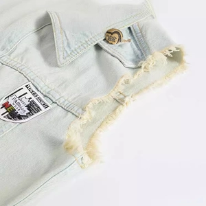 Slim fit light blue denim vest for men featuring a gold heart button and frayed edges