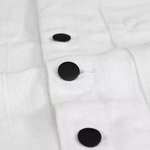 Detailed close-up of white slim fit denim vest showing premium fabric texture and black buttons