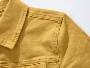 Close-up of ginger yellow denim jacket collar and shoulder with detailed stitching