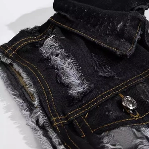 Slim fit black denim vest for men featuring distressed ripped details and metal button