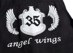 Detail showing the white angel wings print and number 35 on a black casual vest