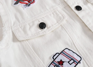 Close-up of white denim vest featuring black buttons, chest pockets, and eagle embroidery patch