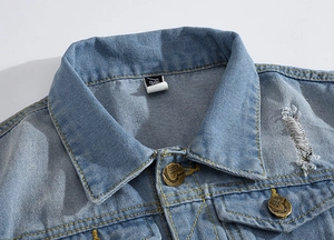 Detail of light blue denim vest showing vintage metal buttons and distressed shoulder hole