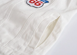 Detail of white denim vest featuring Route 66 patch and reinforced double stitching