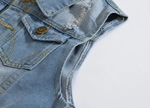 Detail view of light blue denim vest showing distressed holes and yellow contrast stitching