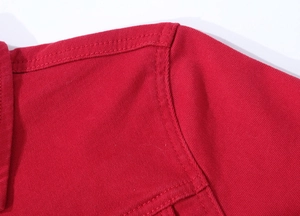 Close-up of red denim jacket collar showing durable double-stitching details