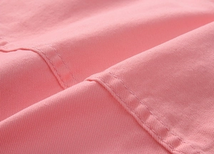 Close-up of pink denim fabric texture with high-quality parallel double stitching detail