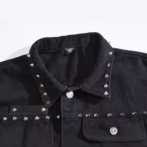 Men's black denim vest with punk silver studs on the collar and metallic buttons