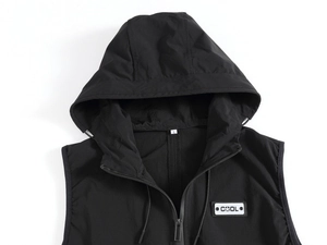 Detail view of black hooded vest with metal zipper, drawstring, and COOL emblem patch