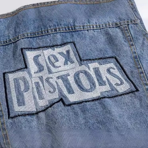 Men's blue denim vest featuring Sex Pistols embroidery in a punk rock style