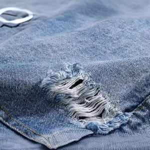Men's slim fit blue denim vest with distressed ripped details and cotton fiber texture