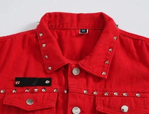 Detailed close-up of red denim vest collar featuring silver cone studs and metal buttons