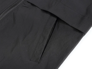 Detailed macro shot of the black casual vest showing invisible zipper pocket and nylon fabric