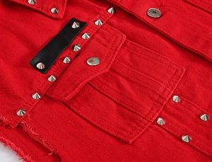 Detail of red denim vest featuring silver metal studs and frayed hem style